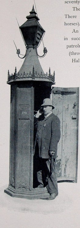 An officer makes a call from a Wilmington police call box.